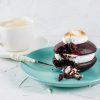 Classic Chocolate & Toasted Marshmallow Whoopie on a plate with a cup of coffee